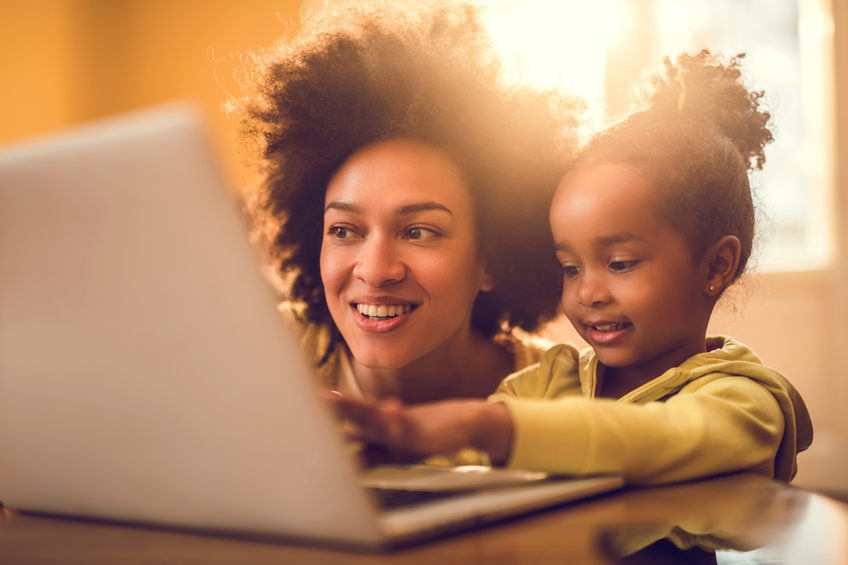 Woman and child looking at laptop